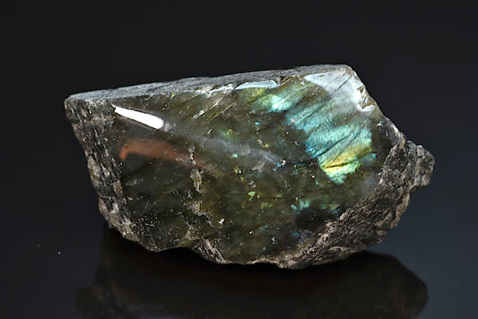Labradorite minéral poli sur une face brut avec reflets de couleurs de Madagascar